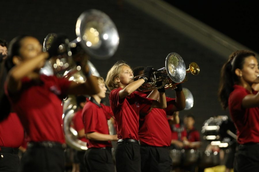 MARCHING ON THE FIELD: The trumpet section performs in the marching band's halftime performance.