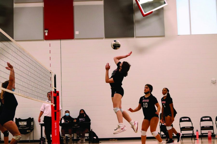 SET AND SPIKE: Freshman Grace Nesrsta jumps up to spike the ball. The Bowie Flex volleyball team, which consists of freshman and sophomore girls, lost to Akins 25-23.