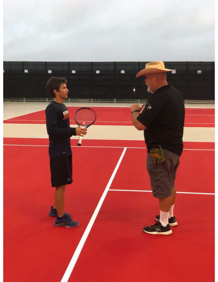 LECTURES IN PRACTICE: New tennis head coach Craig Powell instructs junior Nicolas Ospina during morning practice.  The team returned to practice after last week’s 11-0 loss to Westwood High School. 