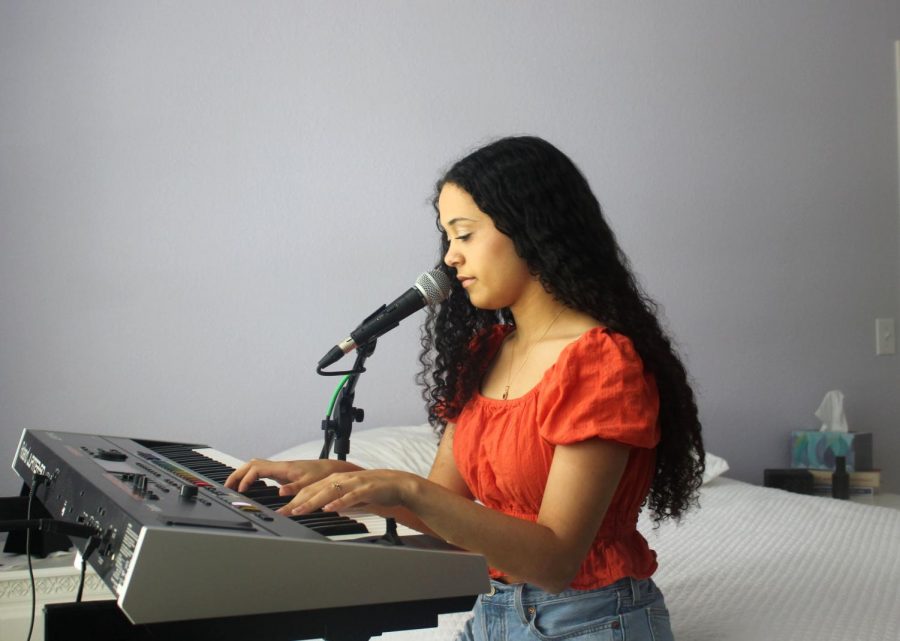 PURSUING HER PASSION: Senior Sadie McDonald practices one of her original, copyrighted songs. McDonald has been singing, as well as playing guitar and piano, since she was four years old. 