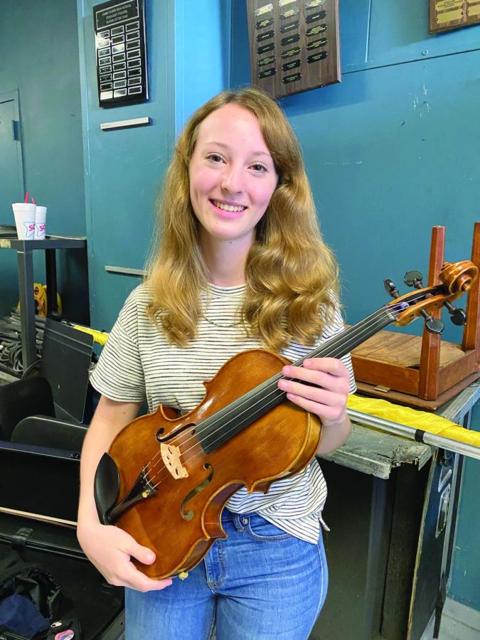 SHOWING OFF HER INSTRUMENT: Senior Grace Gum smiles for the camera. Gum has made it into the All-State orchestra in all her four years of high school, and is the first Bowie student to accomplish this feat since 2018.