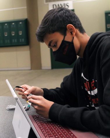 COLLECTING IMPORTANT DATA: Junior Rohan Dharwadker plugs his 3D printed mini electrocardiogram device into his computer. Dharwadker was diagnosed last February with an arrhythmia, or irregular heartbeat, and made the device so he could know the exact electrical activity of his heart at a given moment.