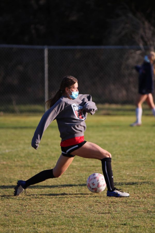 PRACTICE+MAKES+PERFECT%3A+Senior+Lily+Erb+reaches+out+to+control+the+ball+in+practice.+Erb+committed+to+Texas+State+University+to+continue+her+soccer+career+in+college.