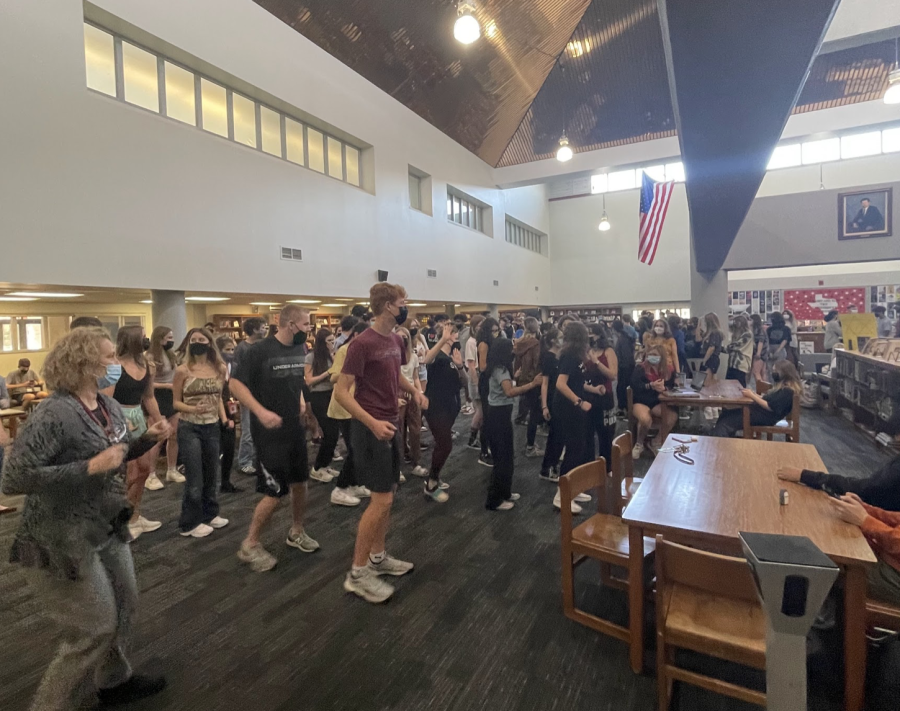 ALL TOGETHER: Teachers and students dance in the library to celebrate 2.22.22.