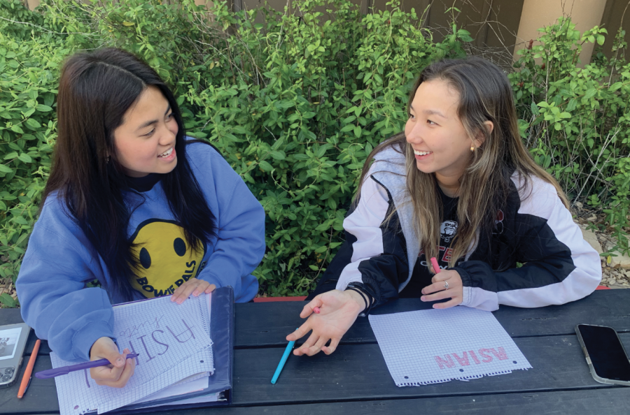 SPREADING ACCEPTANCE: Seniors Vanessa Nguyen and Kelly Matthews spend their morning designing posters to celebrate Asian-History month. Nguyen organizes the AAA and pushes her members to join her in celebration of their culture. 