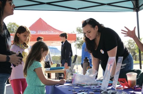 HELPING HANDS: As the tents were set up with different organizations underneath each one, each non-profit had a different activity to offer. Activities ranged from button making, visiting with puppies, making bracelets and many different things for all different age groups. 