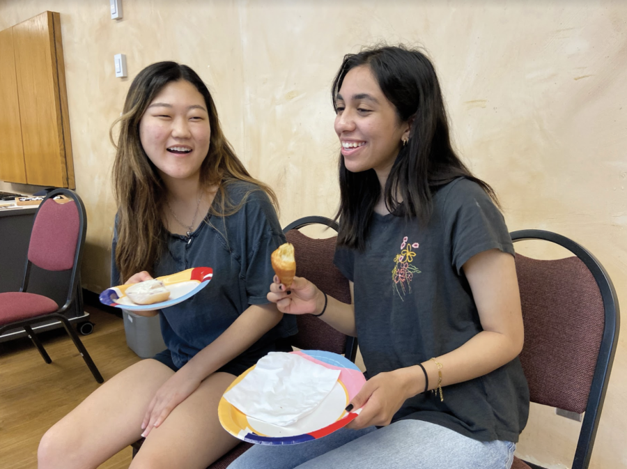 SNACKS AND SMILES: Senior Yuri Lee and Zoya Faisal enjoy their breakfast sponsored by National Honor Society. The breakfast was held on May 18 in the Southwest room. 