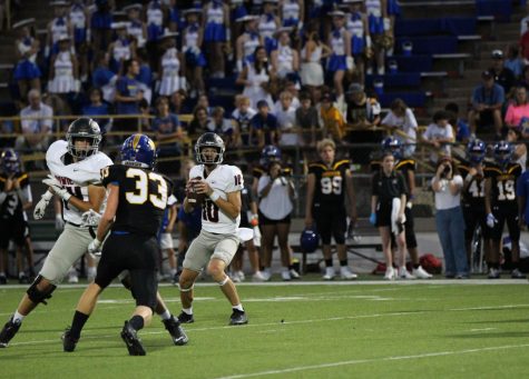 Senior quarterback Conner Kenyon looks to find his receiver down field while under pressure. Kenyon had 17 completions, 201 passing yards, and 15 rushing yards. 