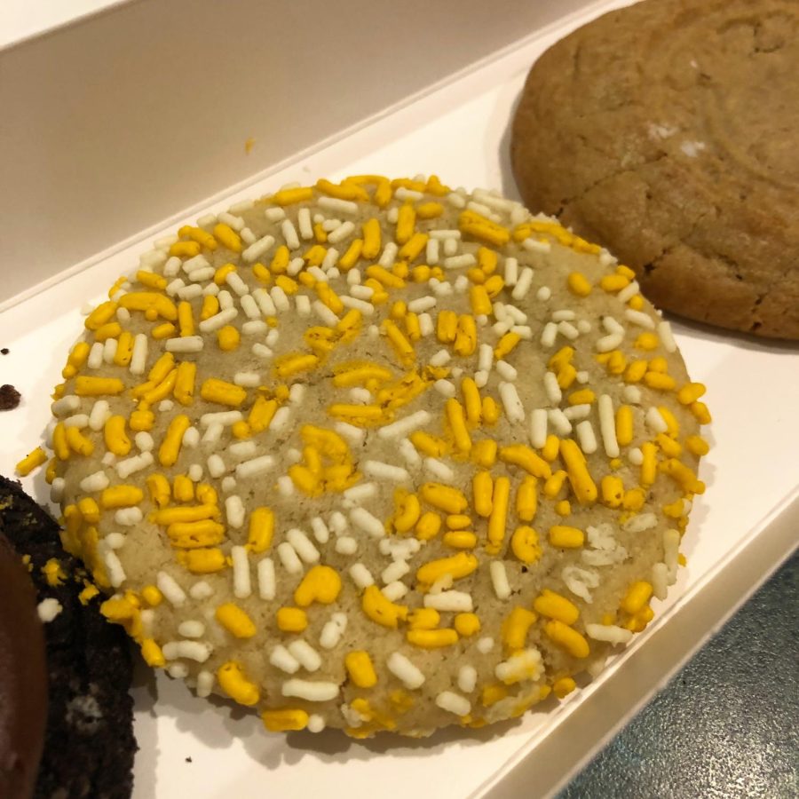 CONFETTI: A sugar cookie covered in yellow and white sprinkles.