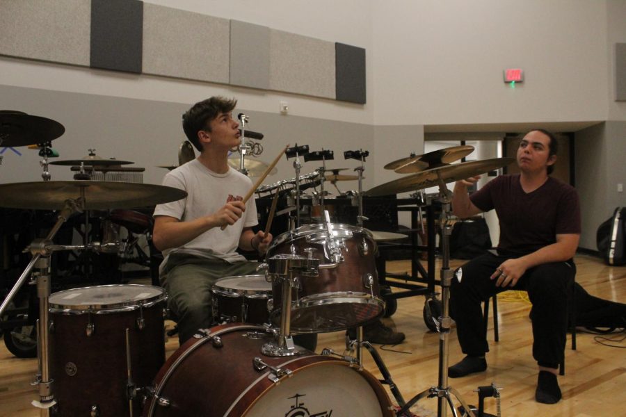 HITTING THE DRUMS: Sophomore John Mann practices his drumming skills during last weeks club meeting. 
