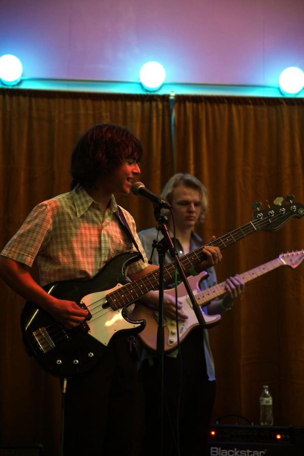 SINGING INTO THE MICROPHONE: Seniors Kyan Blacklock (front) and Richard George (back) perform with their band The Formality at the Tunnel Vision event. Blacklock is the bassist and singer, while George is one of the guitarists.