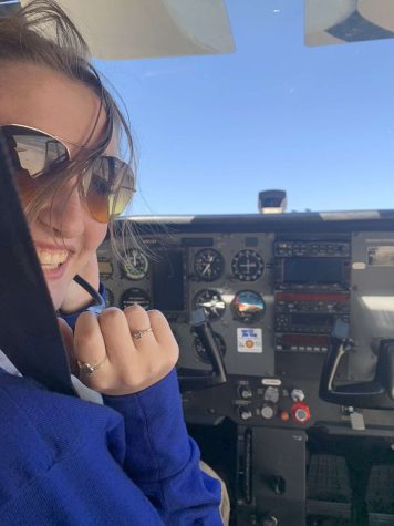 FLYING HIGH: Senior Anni Dotzenrod sits in the pilot seat of a plane for training. She has been working to earn her private pilot license, which requires 40 hours of practice.