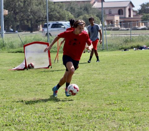PREPARING TO SCORE: Coggins improves his skills on the field with the rest of the Bowie varsity soccer team. The team practices on the field three times a week.