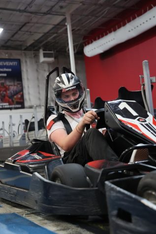 PREPARING TO RACE: Junior Emerson Kindig sits in his go-kart, hands on the steering wheel, ready to take off around the track. Kindig has been training in competitive go-karting at K1 Speed Indoor Racing, being coached by his dad, Michael Kindig, who has experience in the industry as well.