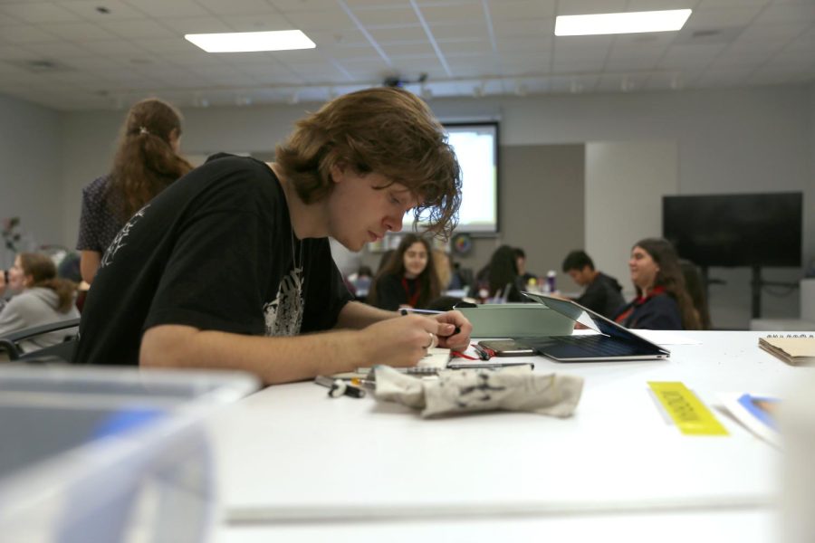 FOCUSED ON HIS SKETCH:  Senior Holden Griffith works in a sketchbook during one of his art classes at Bowie. Griffith has been expanding his techniques in art from a young age, and recently has been doing commissions. He regularly posts his artwork on his Instagram @leoisaki.