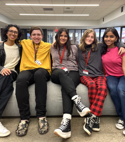 Senior Leanna Reyna, Junior Finnagen Alexander, Sophomore Bubba Infante, and freshmen Izzy Kalyoncuoglu and Anya Cherukuri pose for a photo. The five students were recently featured singing in HEBs holiday commercial.