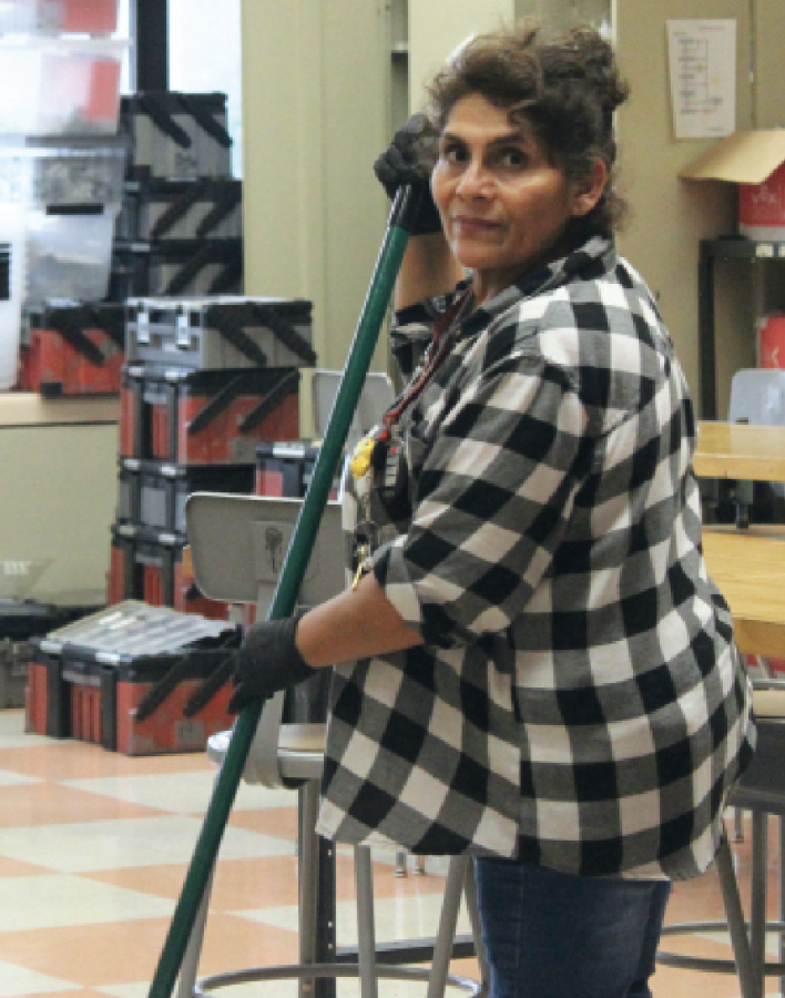 TIDYING AFTER HOURS: Custodian Maria Garcia sweeps room C201. There are 16 custodians on campus currently.