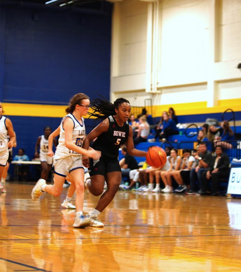 COAST TO COAST: Junior Micah Walton dribbles the ball down the court against Anderson High School. The Bulldogs ended up defeating the Lady Trojans 74-16.