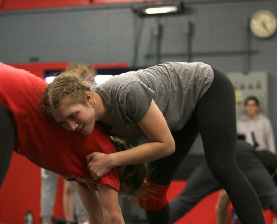 PRACTICE MAKES PERFECT: Senior Olivia Moreno and junior Elayna McKinney spar during a Wrestling practice. McKinney started wrestling her freshman year of high school and has been an important piece of girls wrestling at Bowie. 