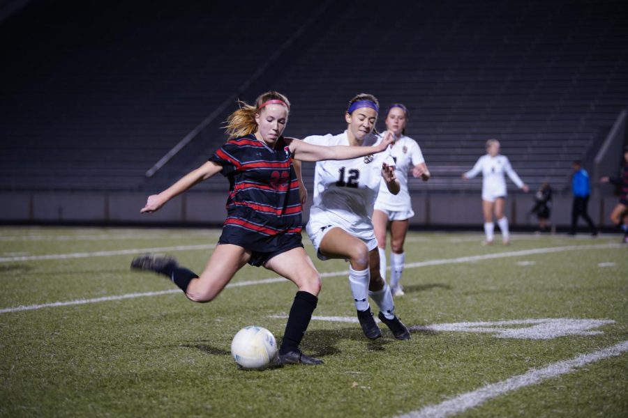 CLEAR: Liz Luck clears the ball right before the the Lake Travis defender can stop her. Depsite her valiant effort, the Bulldogs lost 5-0 to the Cavaliers. 