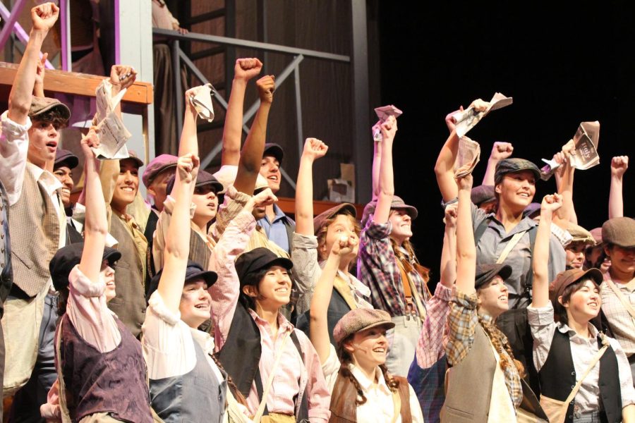 FISTS TO THE SKY: Members of the Starlight Theater Company (STC) hold their hands up high as they beam their smiles into the audience. The whole cast gathered together onstage to joyfully thank the students and staff who took the time to come out to the theater to watch their show. “I really believe that all of our audiences enjoyed the show,” Fleming said. “We put our all into every production, every night. We really tried to make sure everyone in the audience left the theater feeling happy and fulfilled with the show we put on for them.”
