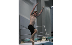 Senior Tucker Lawson jumps off the diving board for the 1 meter diving tournament.