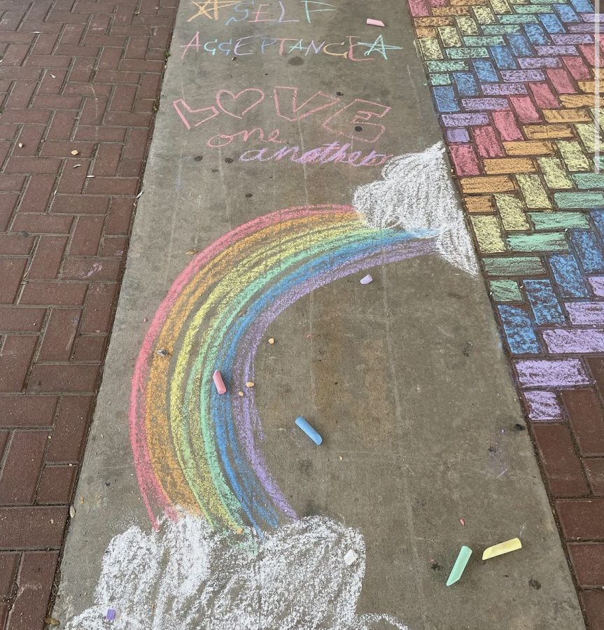 WELCOMING STUDENTS WITH PRIDE: SAGA members decorated the outside of the school with colorful chalk.