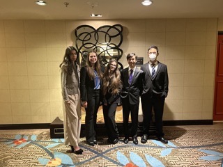 Gathering together in the walkway after winning state for BPA, juniors Imaan Dadaboy, Kaitlin Kaiser, sophomore Ryleigh Carrasco, seniors Cade Harrison and Arthur Chen get one last picture together before receiving their separate awards.