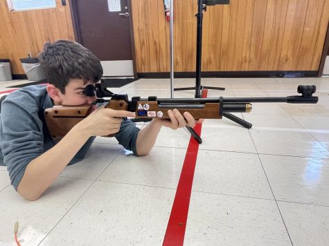 Junior James Bisone practices in the renovated bluebonnet portable. The portable is equipped with custom targets, racks for airsoft guns and a competition board. 