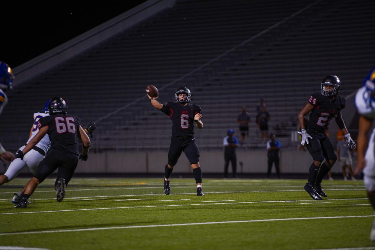 QB Cruz Tello (Junior) looks for an open receiver. Tello had a total of 2 touchdowns and 264 total yards (164 passing and 103 rushing) at the recent varsity football game against Anderson. 