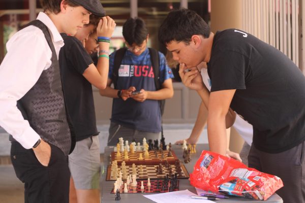 Members of the Chess club challenge students to a chess match during the Club Fair for fun prizes.