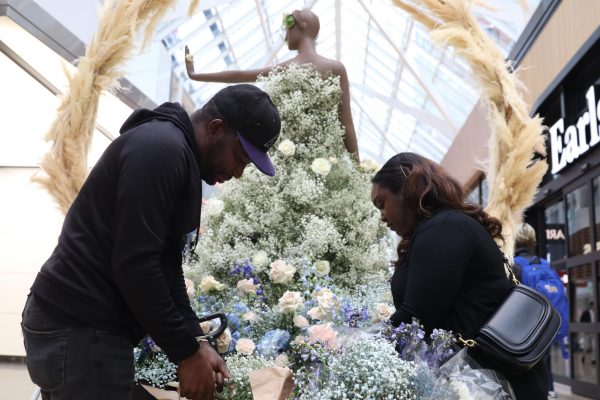 Floral designers Yanique Shaw and Carlos Hitchman work to keep their flowers looking how they want. 