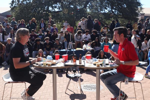 LETS GET DOWN TO BUSINESS: History teachers Karl Lauer and Alejandro Garcia begin the first lunch wing-eating contest. Students voted to nominate four faculty members to compete in the contest, resulting in a face-off each lunch period.