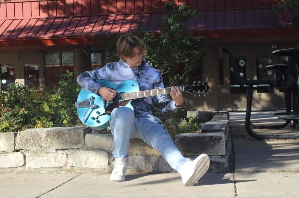 STRUMMING A TUNE: Freshman Alex Doles practices an original song which he has been working on for the past couple of weeks. Doles plans to release a holiday special this December that will have a variety of music genres.