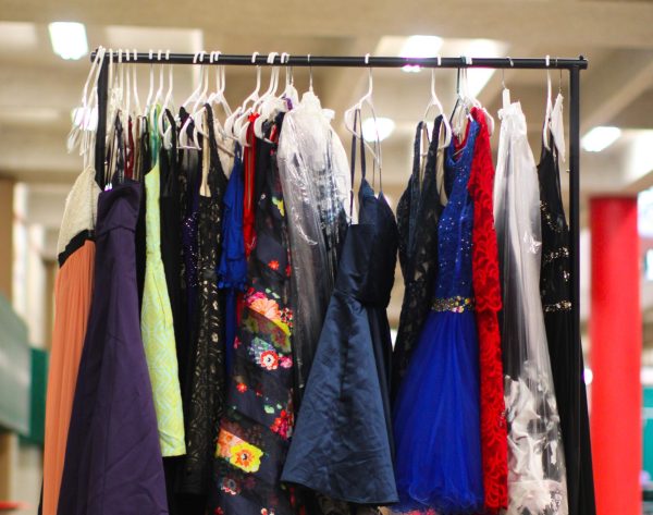 A SPARKLING INVENTORY: A shining array of formal dresses can be seen hanging on a clothing rack outside Kristin Mijares downstairs B-hall classroom. With the help of her community, Mijares was able to collect donated clothing items and provide Bowie students with free prom attire. 
