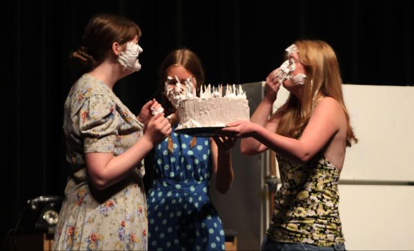 CAKE TO THE FACE:  Lillian Joy, Tess Roadman and Caroline Otstott end the play Crimes of the Heart by smearing cake onto each others face. They are participating in Bowie’s one-act plays, short productions directed by seniors that delve into emotional topics.