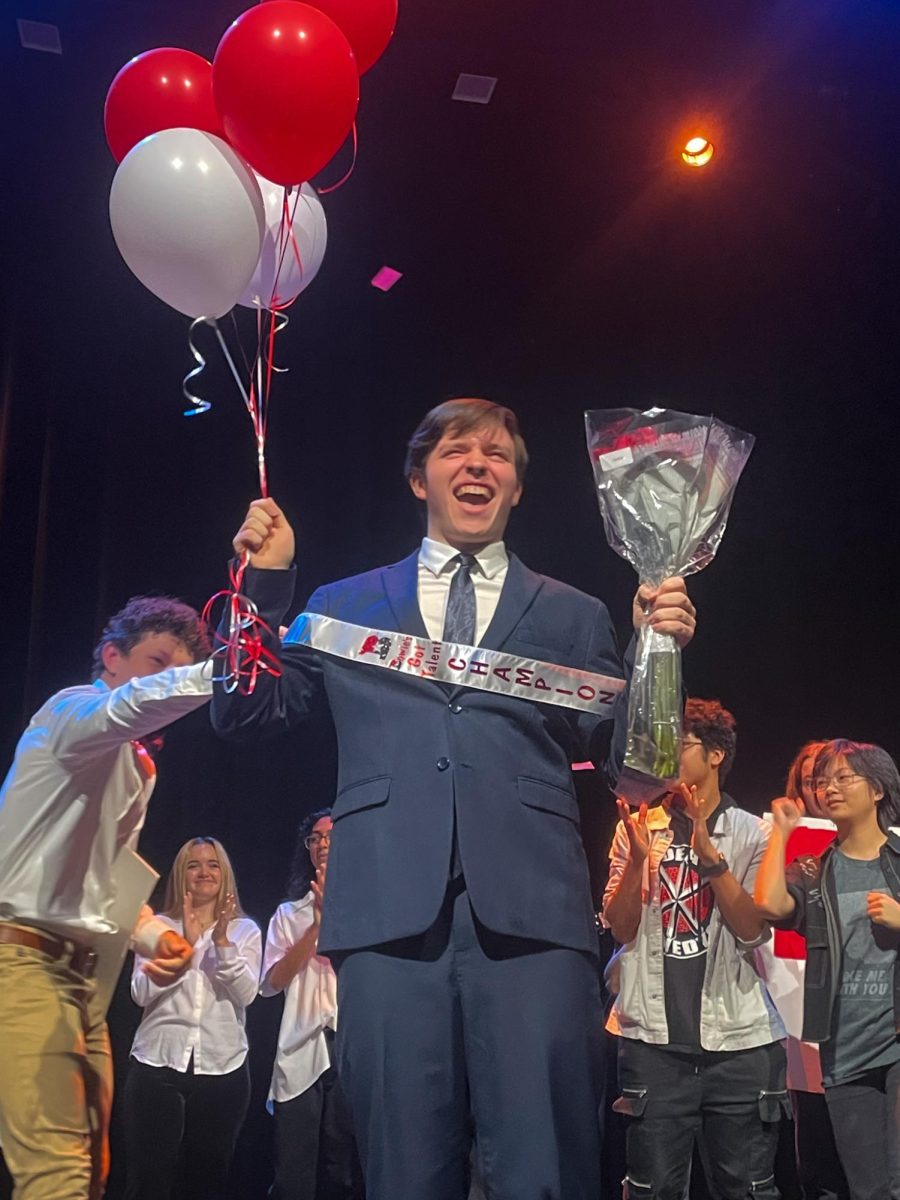 CELEBRATION STATION: Senior Finnegan Alexander stands center stage, with flowers, balloons, and a sash, after being named the winner of Bowie’s Got Talent. Alexander performed a rendition of My Way by Frank Sinatra. 