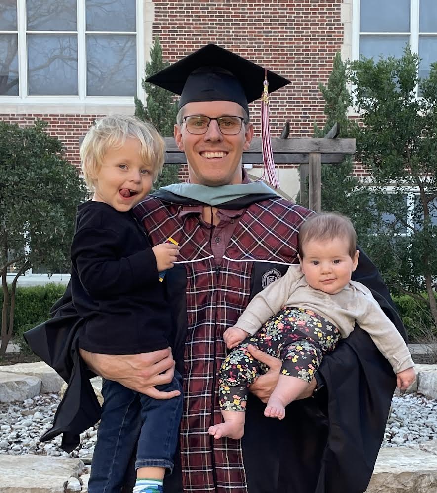 CAP AND GOWN: Babies in hand, government and economics teacher Dalton Pool poses with his family at graduation. For the past couple of months, Pool has been taking courses for a principal certification in hopes of becoming a vice principle in the future. 
