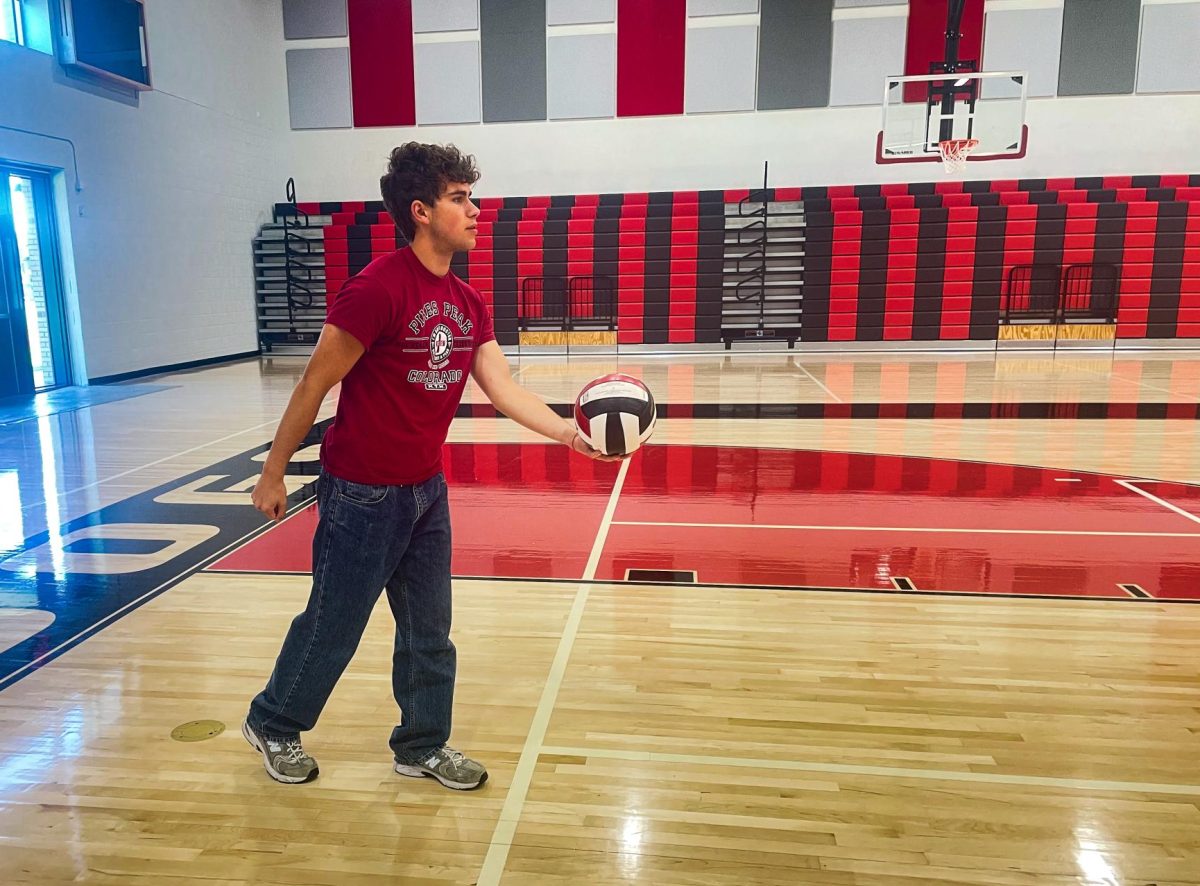 PRACTICE MAKES PERFECT:  Senior Lucas Burcham practicing his volleyball serve after school. The tournament is only a couple weeks away, starting the first week of May.