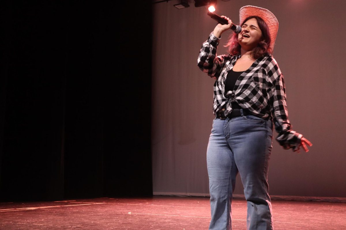 UNDER THE SPOTLIGHT: Bex Cao-Spurlock took the stage with Jolene by Dolly Parton. Cao-Spurlock is one of the directors for Cabaret and sang Jolene for the 70’s section of the show.