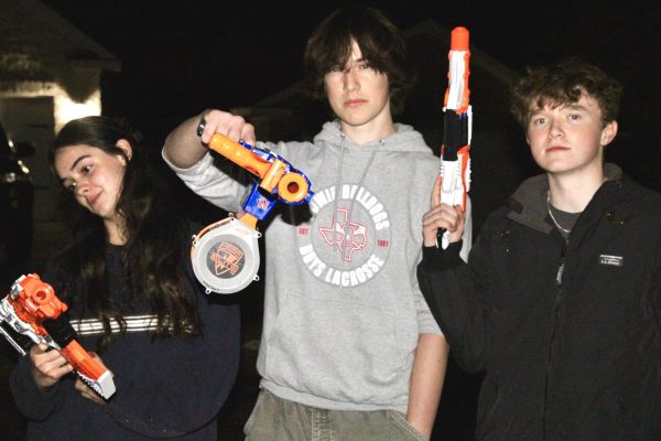 WEAPONS UP: Sophomore Gabriella Bochey, sophomore Will Olenick, and senior Austin Ikard pose with their Nerf guns. Their team, the Adderall Annihilators, lost in the third round of the Nerf war.