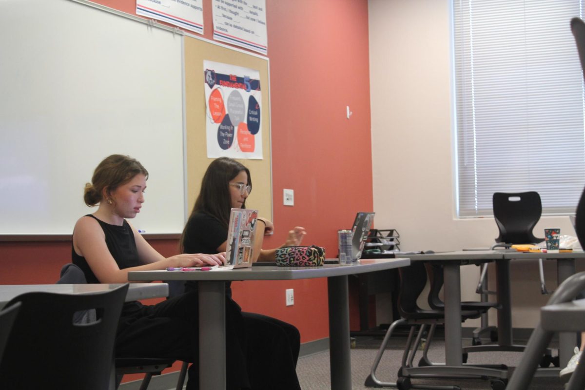 Senior Debate Captains Olivia Baird and Sofia Yordanova read out arguments in their Public Forum competition.