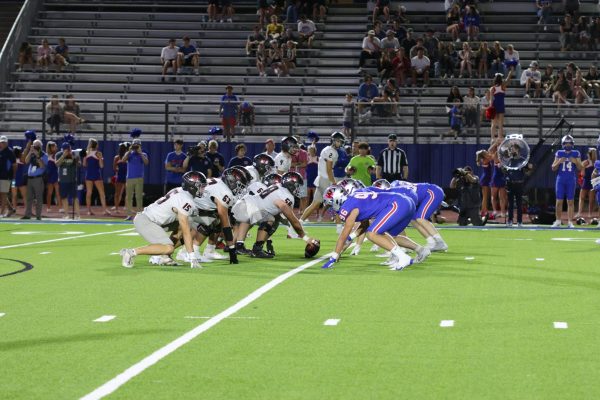 The Westlake and Bowie team brace for impact as Bowie prepares to snap the ball against Westlake's defensive line.