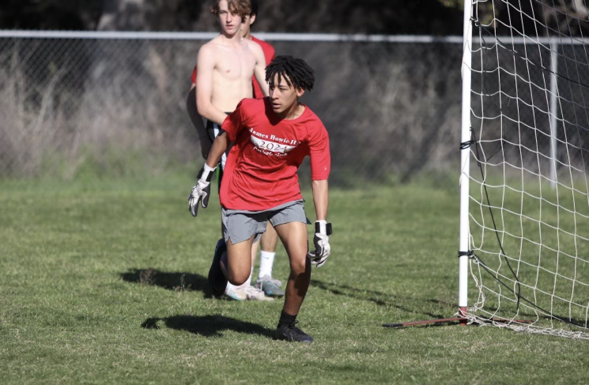 KEEP YOUR GUARD: Sophomore Carter Jones defends his goal during soccer practice. Soccer students have practice every day after school. 