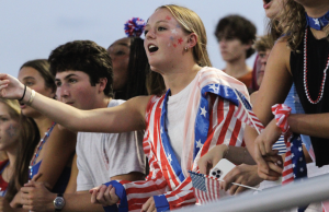 WATCHING THE GAME: Senior Macy Scott wears her stars and stripes and cheers on the dawgs. Seniors get front row priority in the student section at football games. “It was a lot of fun to be there for our first home game,” Scott said. “I enjoyed the theme and I thought the student section brought great energy."