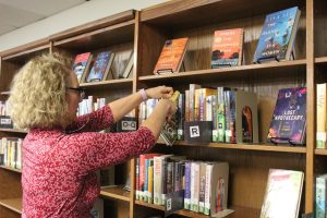 FILING AWAY: Librarian Tara Walker-Leon puts away books in the library. This is one of the many responsibilities that Walker-Leon has on a daily basis. 