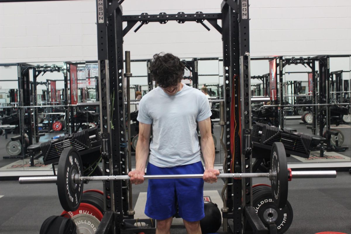 Ari Bernsteins’ veins pop as he struggles to lift the bar above his waist and up to his chest. Bernstein works out at either Crunch or the school gym daily. 