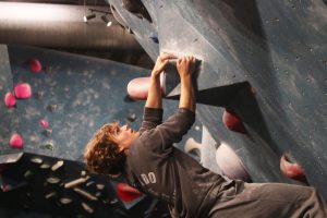 GETTING A GRIP:  Junior Colton Demetri attempts to climb a dyno at Austin Boudlering Project. Colton had been going to ABP for awhile before the formation of the club. “I usually go to ABP a lot outside of the club,” Demetri said. “My favorite part is the cave area, especially when there are good colors.” 