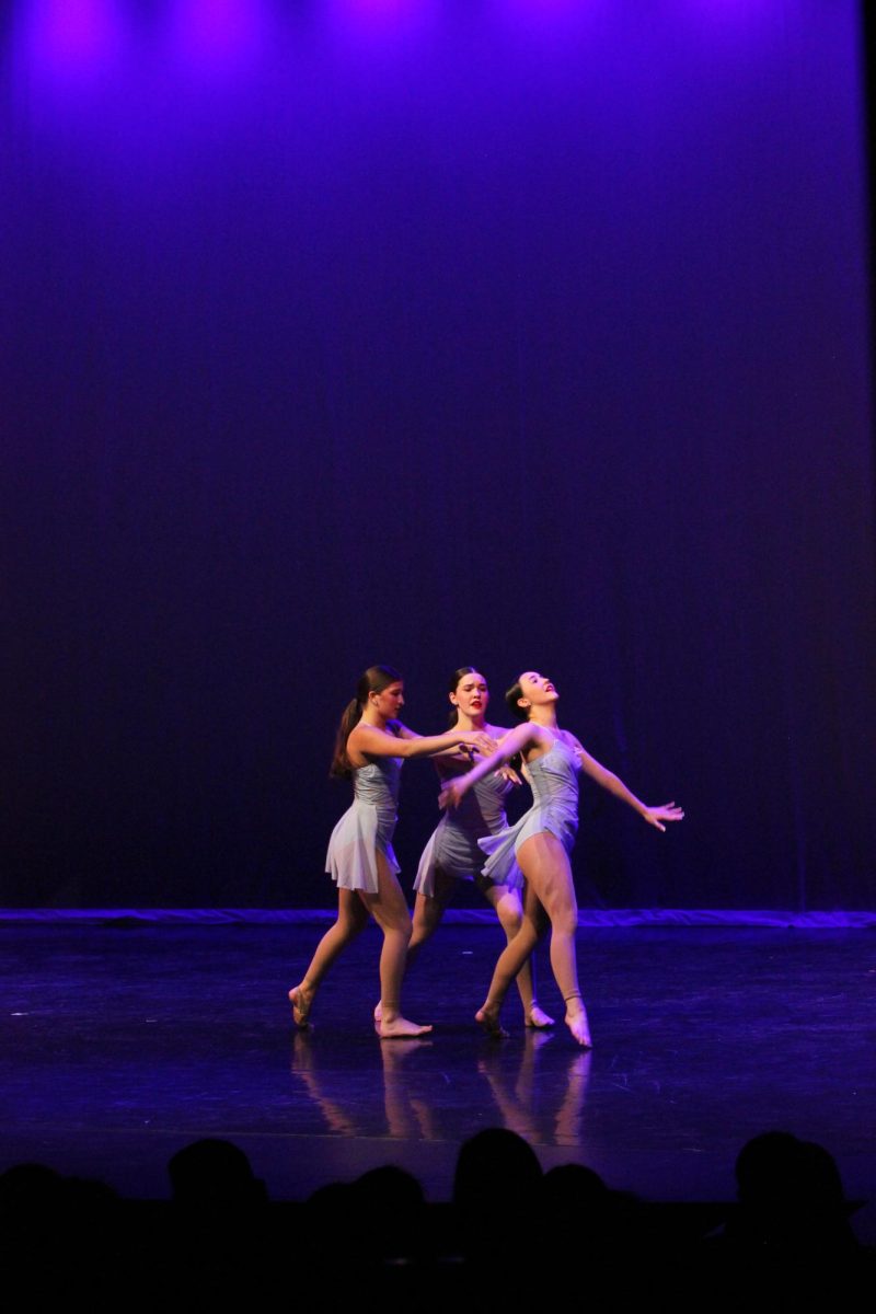 BEAUTY AND GRACE: Silver Star Trio Anna Deeb, McKenna Mulig, and Emily Saucedo focus as they show perfect coordination in their dance to the song “Saturn”. With every step a new feeling is shown through their movements and reactions. 