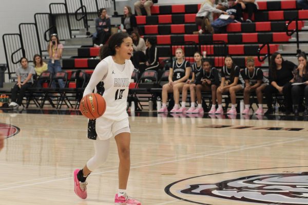 COMMANDING THE COURT: Sydney Ashby brings the ball up the court.  Being the point guard, Ashby calls the plays in order to get the offense started.